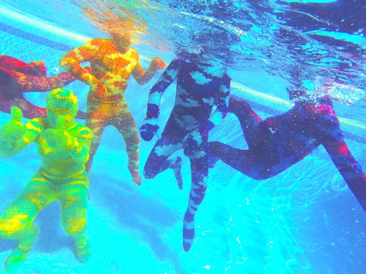 Swimming underwater in Olek crocheted bodysuits