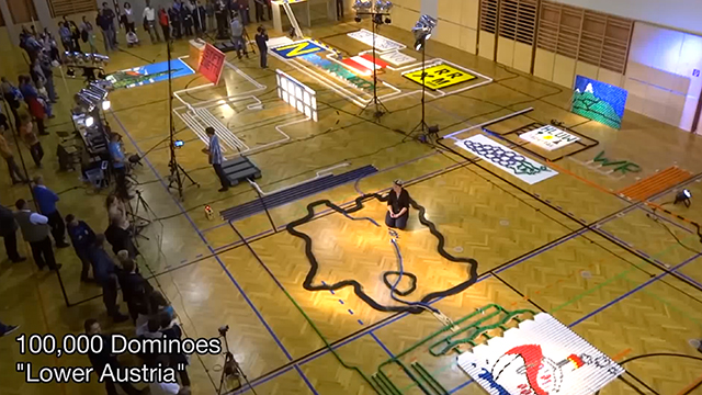 Super Tall Domino Structure Falls at the End of 100,101-Piece Domino Course For Guinness World Record