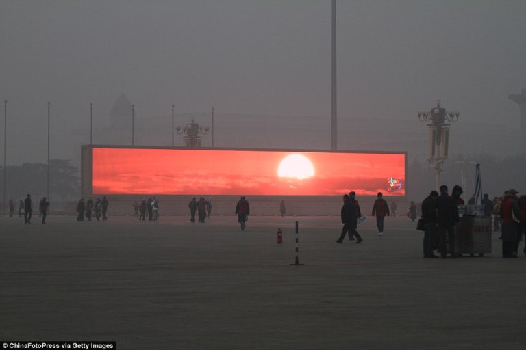 Giant Screens Display Sunrise in Smog Shrouded Beijing