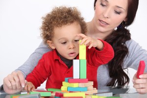 Woman and child playing with building blocks