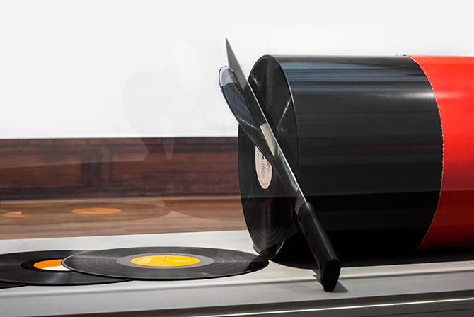 A Punny Sculpture of Records Being Sliced off a Vinyl Sausage