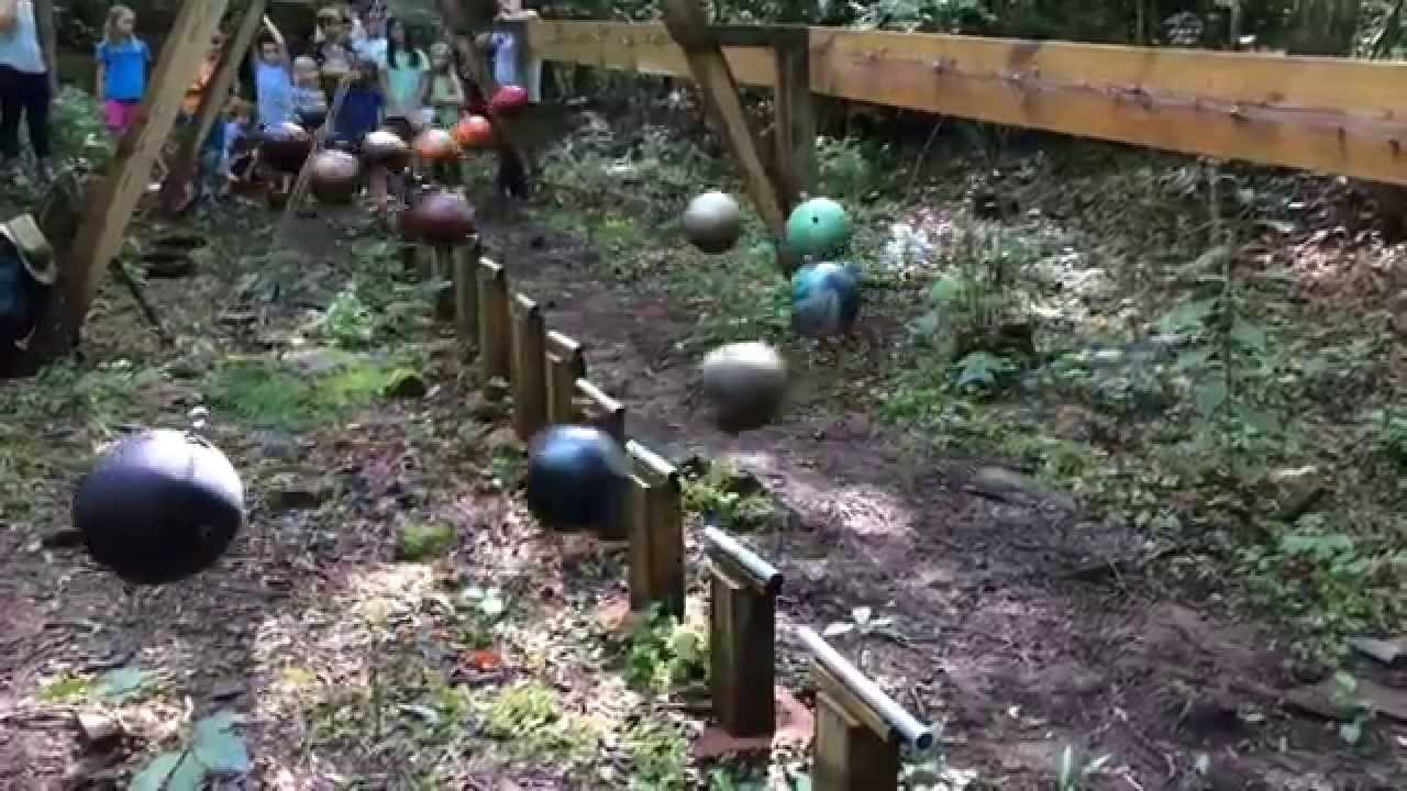 An Outdoor Installation Featuring 16 Bowling Ball Pendulums That