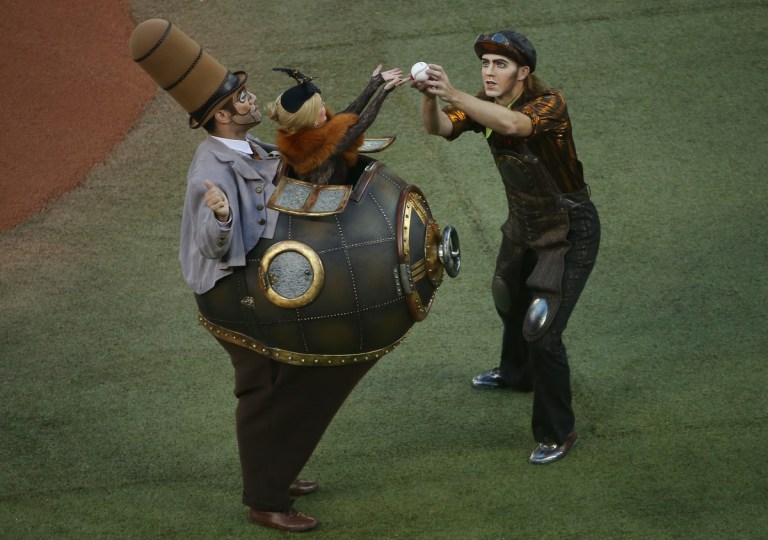 Cirque du Soleil cast members threw out the first pitch