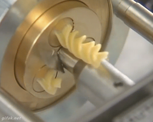 A Pasta Machine Slicing Rotini in a Hypnotic Never-Ending Loop