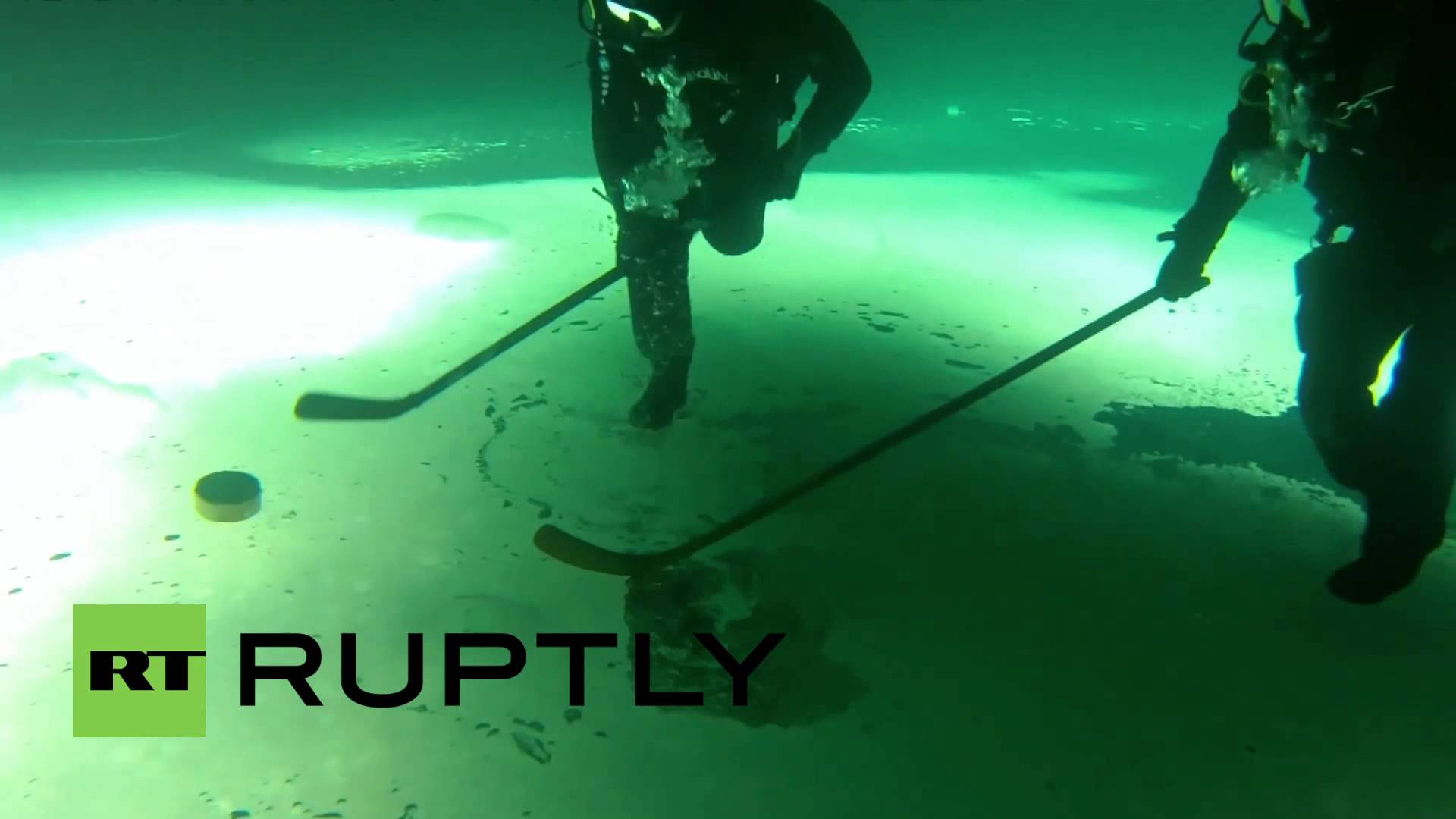 Divers Stage a Disorienting Game of UpsideDown Ice Hockey Beneath the