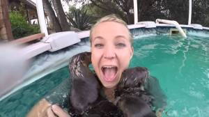 Wild Kingdom Host Stephanie Arne Joyfully Envelopes Herself In a Swarm of Baby Otters