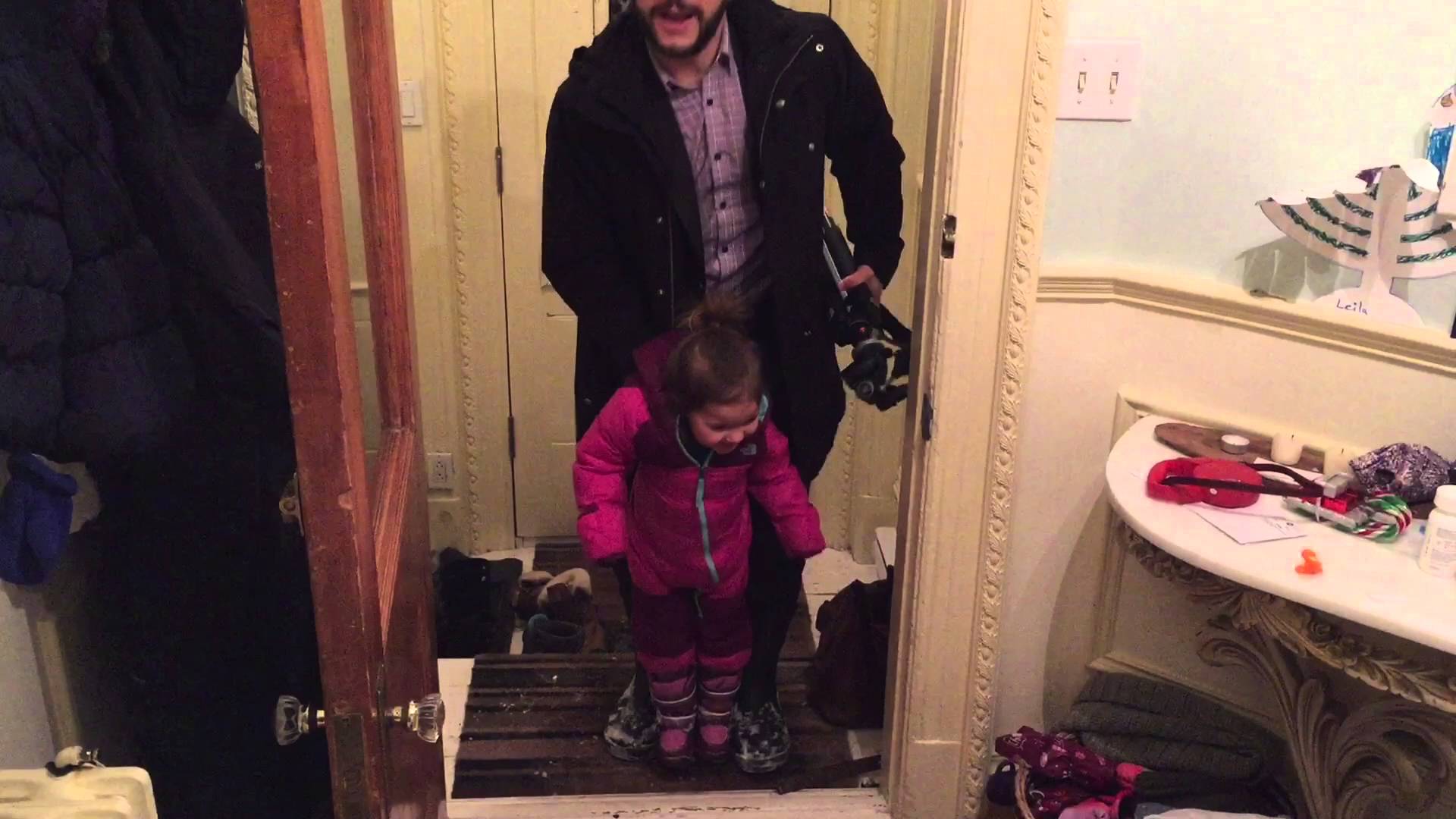 an-incredulous-toddler-laughs-wildly-as-her-father-tries-to-explain-how