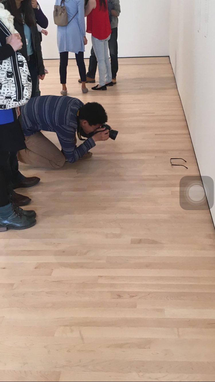 Man Photographs Glasses on Floor
