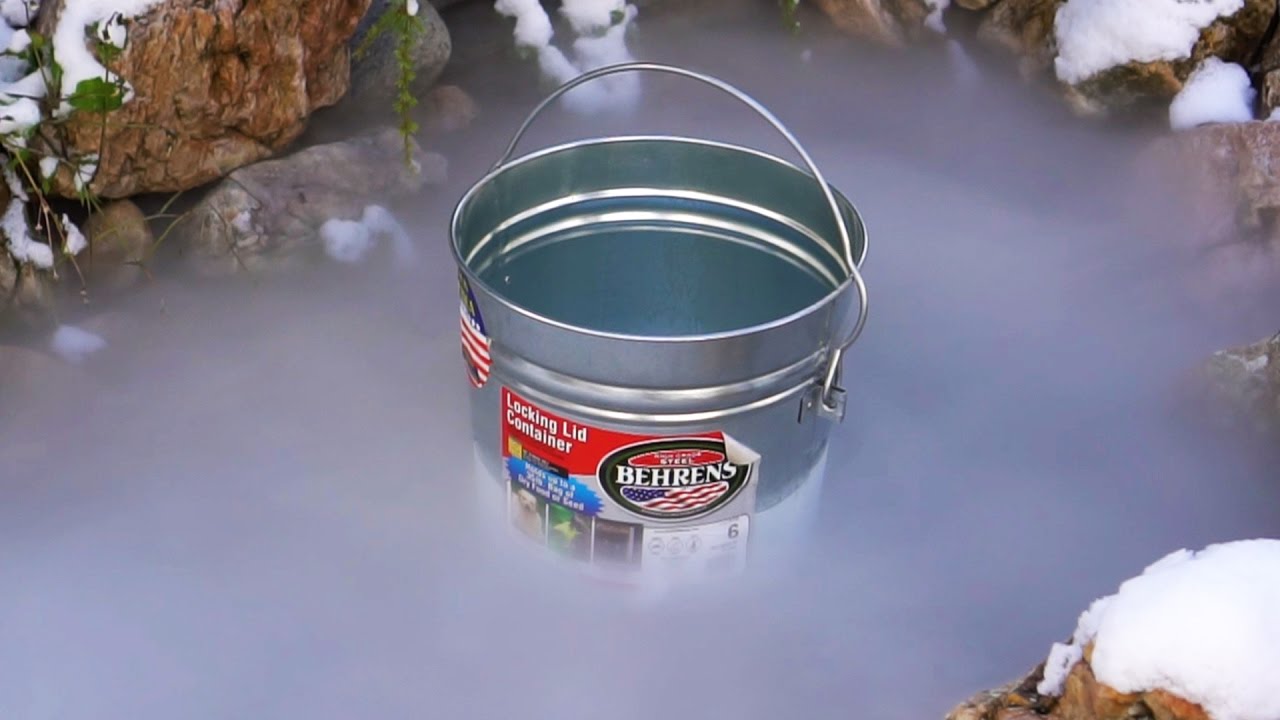 Dumping Dry Ice Into a Frozen Pond With a Thin Layer of Ice to See How