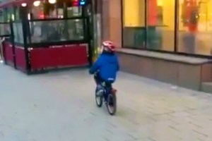 Little Boy Distracted by a Racy Strip Club Ad on Van Says 'Ooh La La!' and Crashes Bicycle Into a Wall