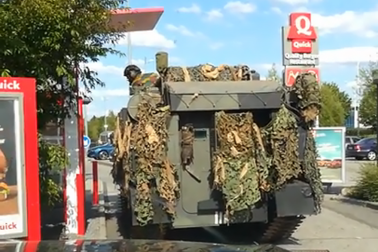 A Belgian Military Tank Orders Food From a Fast Food Restaurant Drive-Thru