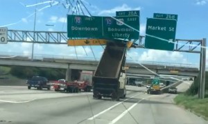 Big Rig With Raised Truck Bed Flips Over After Crashing Into Highway Sign at Full Speed