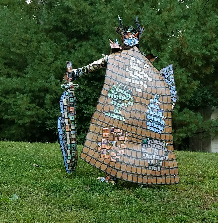 A Lady Makes a Suit of Armor, a Weapon, and a Shield Out of Magic The Gathering Cards