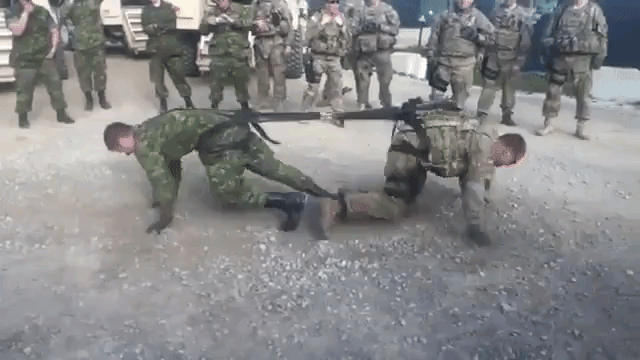 Canadian and American Soldier Face Off In a Friendly One-On-One Game of Tug of War