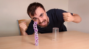 Determined Man Quickly Learns How to Stack Dice With a Cup