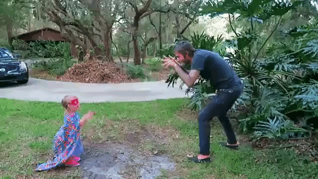 Adorable Little Girl Dressed as Superhero Has Fun Battling Her Evil Villain Father