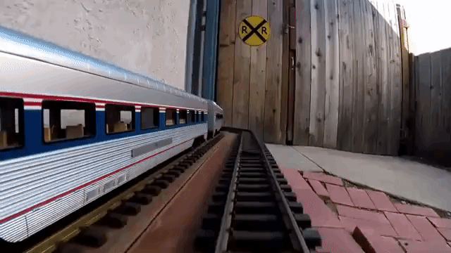 GoPro Footage of an Amtrak Model Passenger Train Traveling Through a Man's Home and Backyard