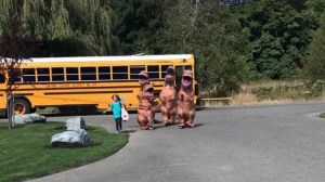 Hilarious Family in T-Rex Costumes Greet Daughter at School Bus Stop
