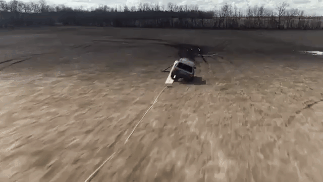 Persistent Man Learns How to Do the Splits While Flipping a Life-Size Remote Control Jeep