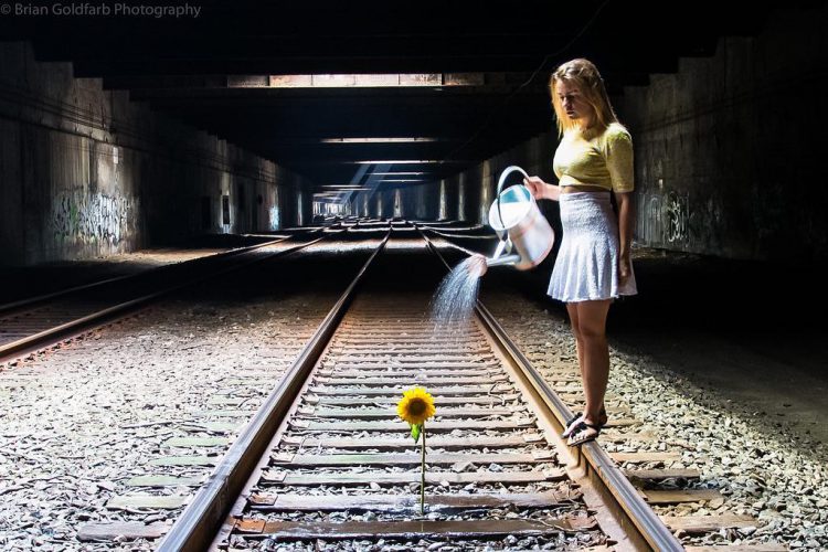Watering a Sunflower in the Subway