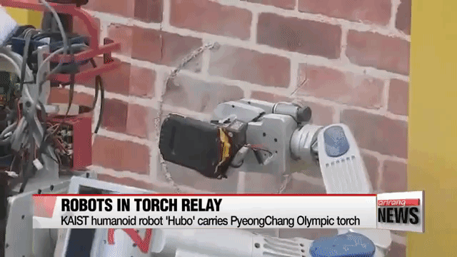 HUBO the Humanoid Robot Carries and Cuts Hole in Wall to Pass On the Olympic Torch in South Korea