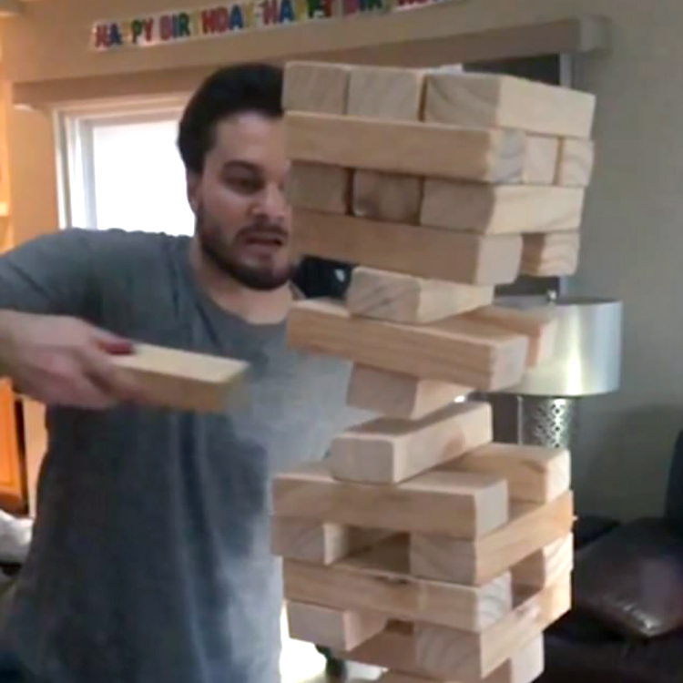 Jenga Wizard Pulls a Single Wooden Block Out From the Center of a Giant Stack and It Stays Up