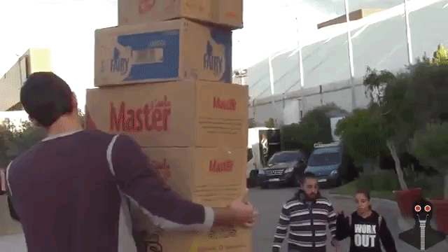 Men Frighten Strangers by Pretending to Drop a Tall Stack of Boxes on Top of Them