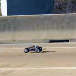 A Remote-Controlled Car Races After a White Truck on Highway 59 in Houston, Texas
