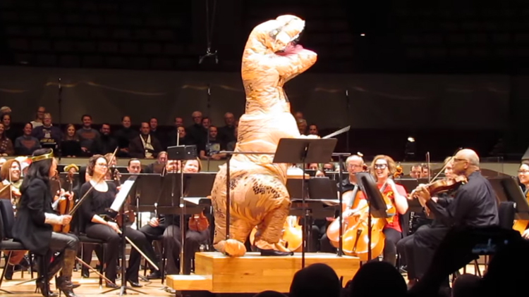 A T-Rex Conducts the Colorado Symphony Playing John Williams' Classic 'Jurassic Park' Theme Song