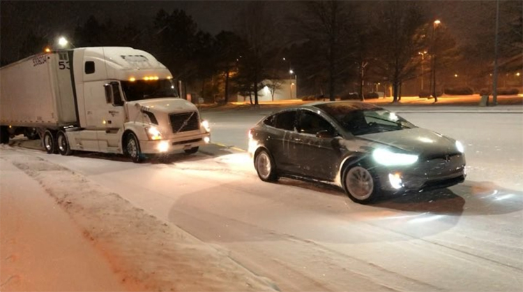 Tesla Model X Electric SUV Tows a Stuck Semi Truck Out of the Snow