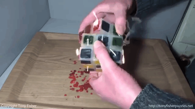 A Daring Man Solves a Lit Rubik's Cube Candle While It Is Burning
