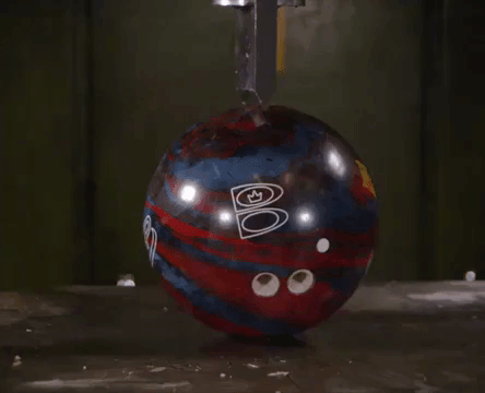 A Hydraulic Press Cuts Bowling Balls, Cameras, and Other Random Objects in Half With a Giant Blade