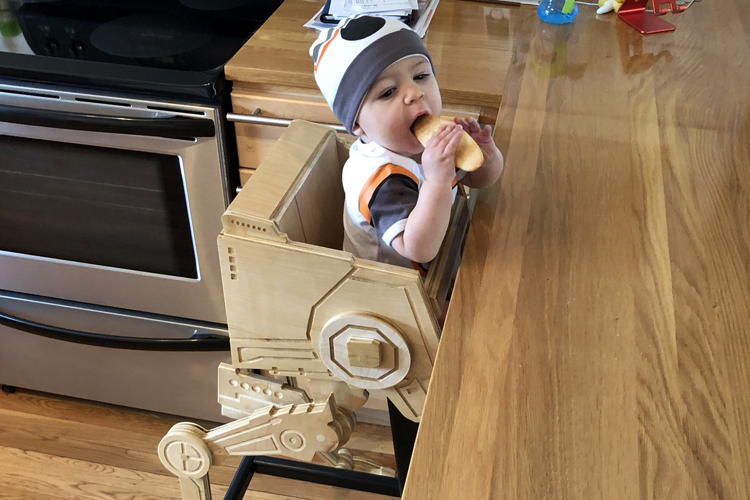 A Wooden Star Wars High Chair That Looks Like an AT-ST Walker