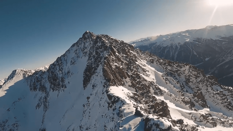 Beautiful Aerial Footage Shot From Two Drones Flying Over Snow Covered Terrain