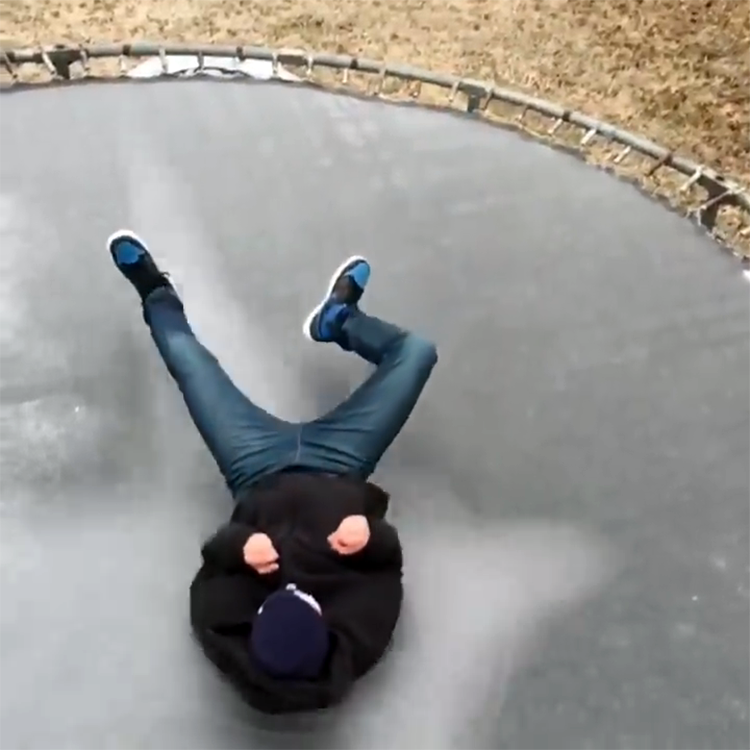 gentagelse absorberende sorg Slow Motion Video of a Teenager Jumping Onto an Ice-Covered Trampoline  Shattering the Surface