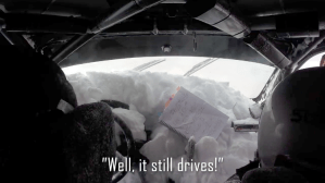 rally car rolls into a snowbank