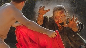 A Half Naked Matador Battles a Zombie to Prove His Worth at a Survivor Camp