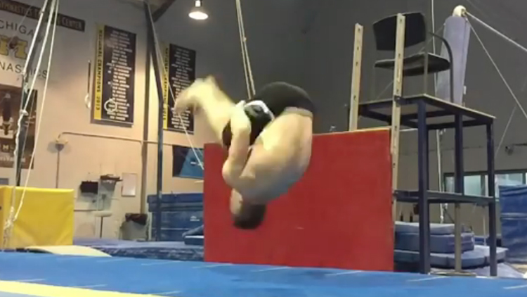 Michigan Gymnast Performs Amazing Hands-Free Backflip From a Seated Position