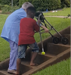 Boy Helps Elderly Woman Up Stairs