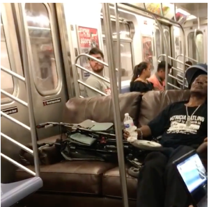 Man Riding Subway on Sofa