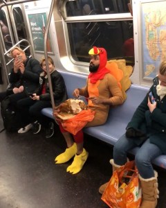 Man Dressed As Turkey Eating a Turkey
