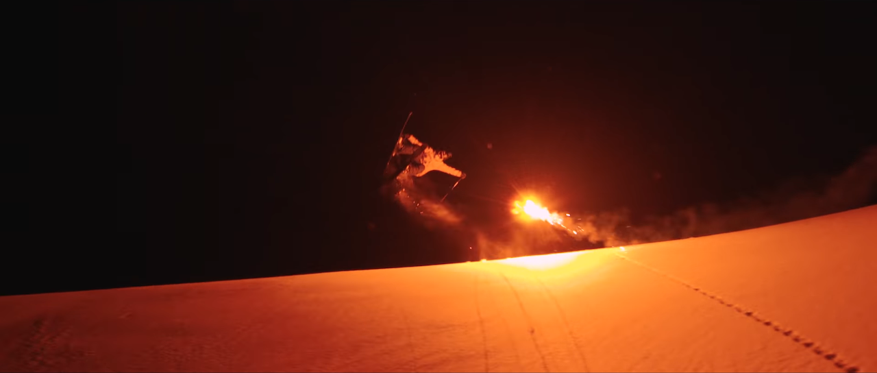 Nighttime Skiing Lit by Red Flares Fired Overhead