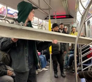 NYC Commuters Help Man With Beam on Subway