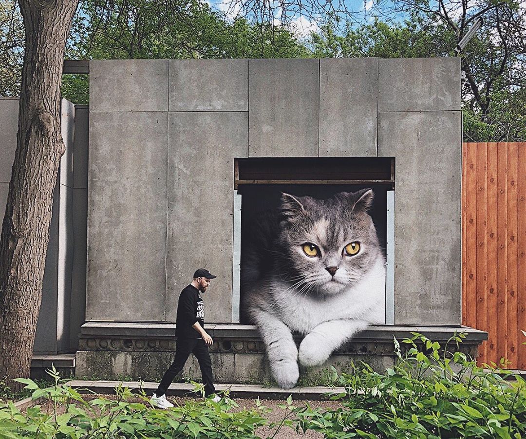 russian-artist-imagines-his-everyday-life-with-giant-cats-looming-over-him