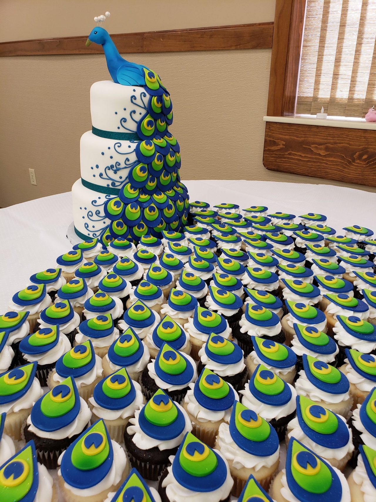 A Gorgeous Peacock Cake With Cupcake Tail Feathers