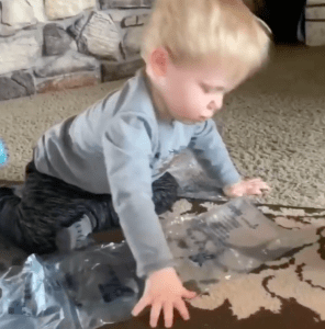 Little Boy Demonstrates Pop Bubble Wrap