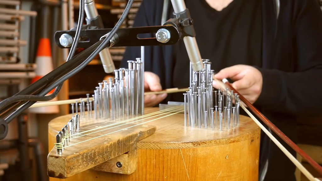 A Handmade Wooden Violin of Various Pitches Made From Sympathetic Nails and Resonant Strings