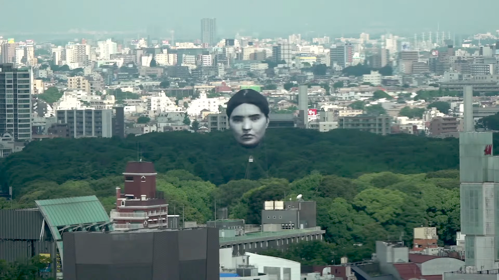 Giant Head Floats Over Tokyo Park
