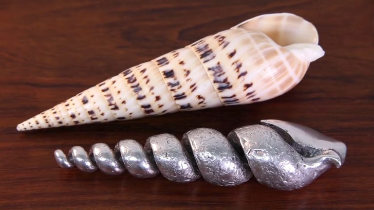 Pouring molten metal inside a seashell