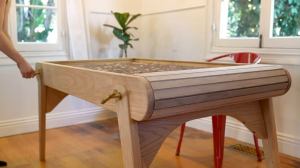 A mechanical table with a hidden table top for puzzles